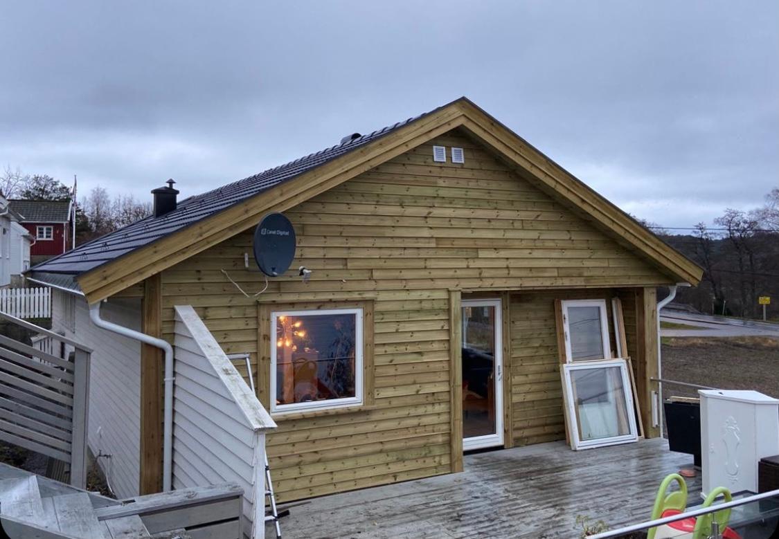 A new timber building with its windows in, before cladding