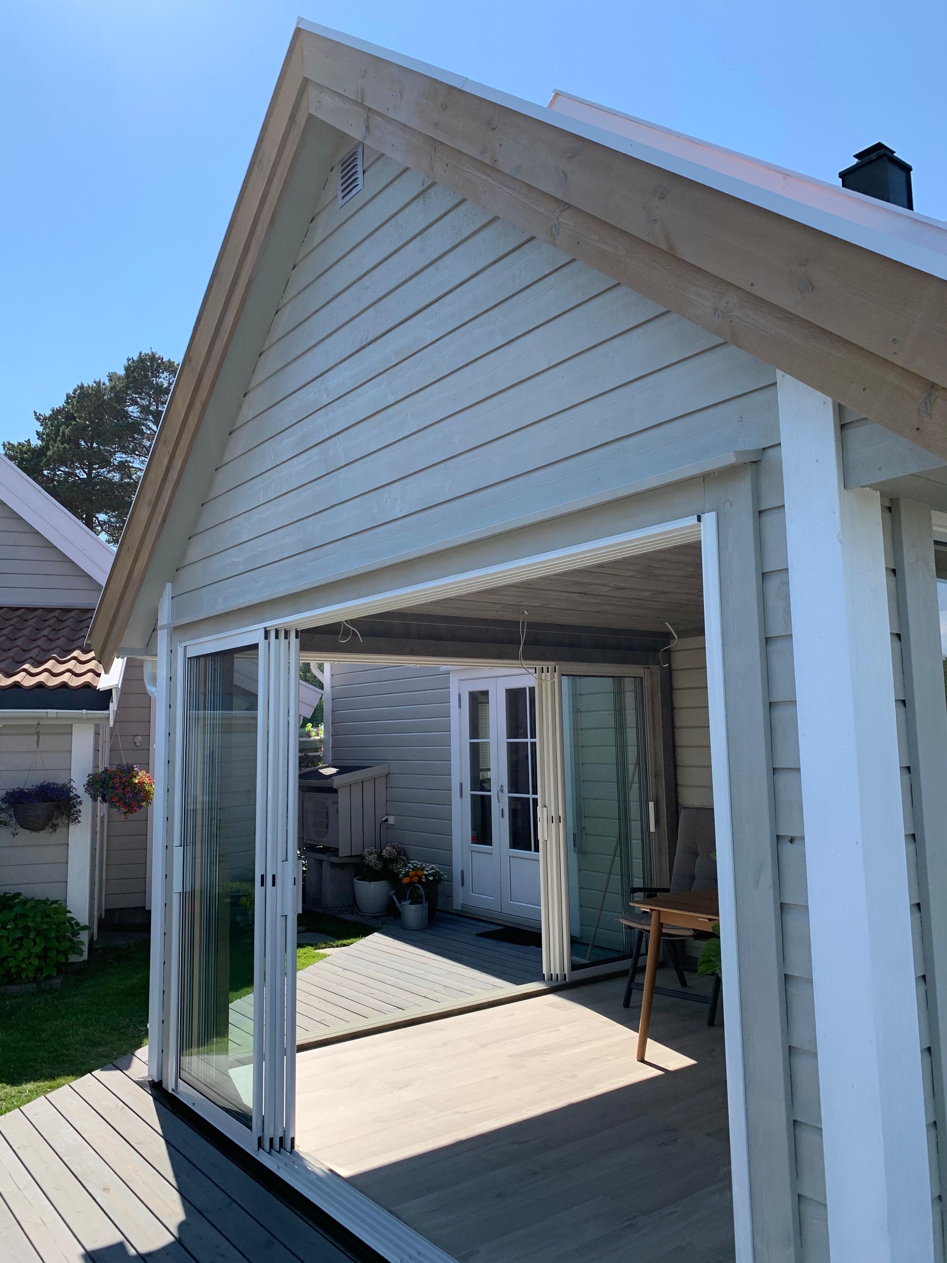 A new covered porch on the side of a white house
